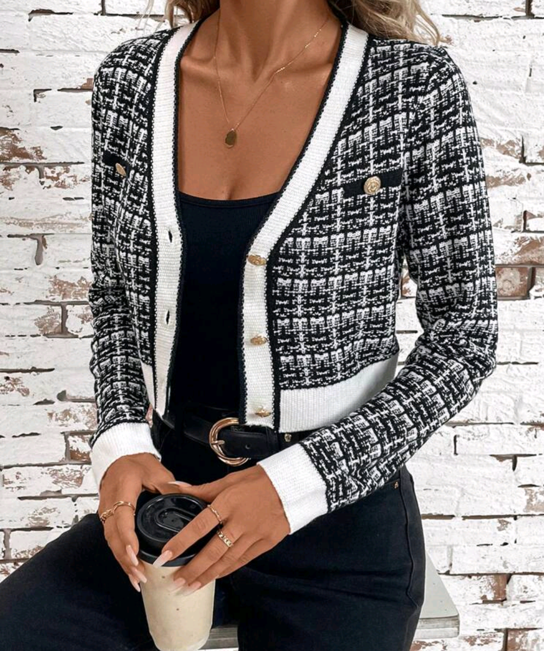 Women's plaid cardigan with contrast trim and long sleeves.